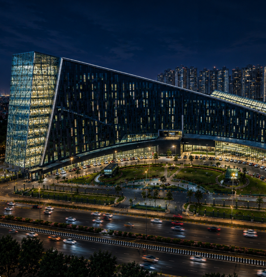 NOIDA Authority complex illuminated at night along a busy urban corridor